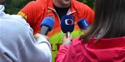 Michal Kulka surrounded by journalists