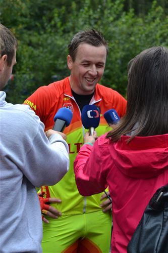 Michal Kulka surrounded by journalists