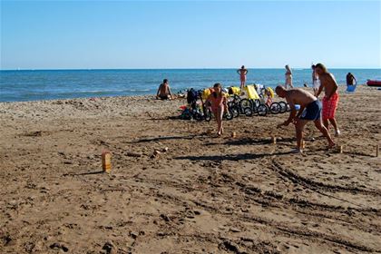 Playing Kubbe on the beach, a throwing game, which demands precision, much like the French pétanque. 