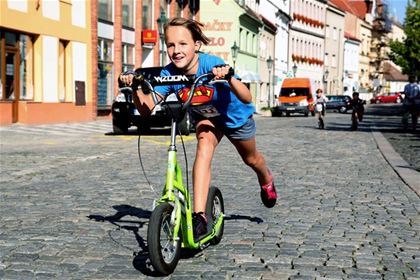 A girl on the Yedoo Wzoom scooter was in the lead on the route of the racing circuits for older children.