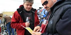 Browsing through the plan of wine cellars with a glass of wine in the hand.