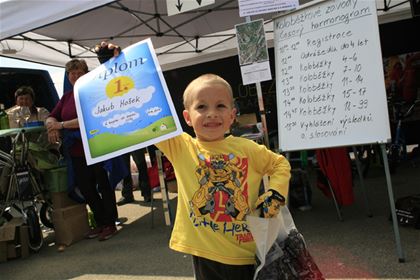 The happy winner of the running bike race is posing proudly for the photographs present.